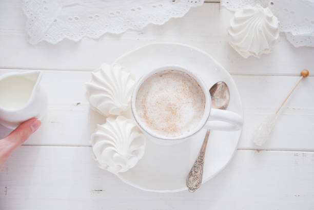 istock Coffee and marshmallow on a white wooden background 874103376