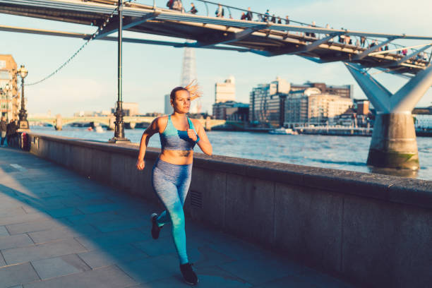 istock Sportswoman jogging in London 874107766