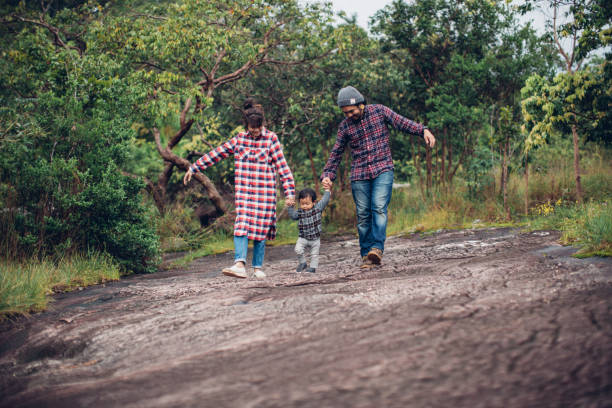 istock Asian parents and baby walking past in a forest 874110092