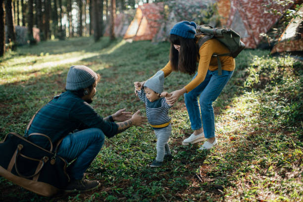 istock Happy baby boy making his first steps on grass in forest. 874111284