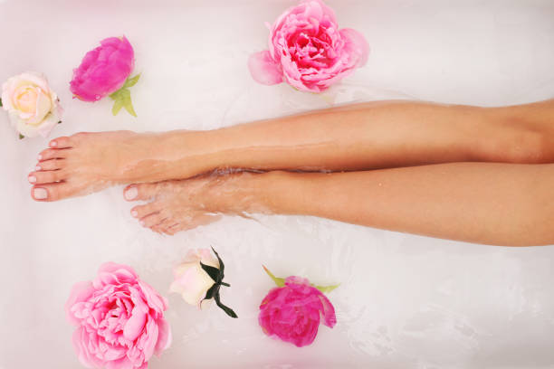 istock Female legs in the bath. 874118796