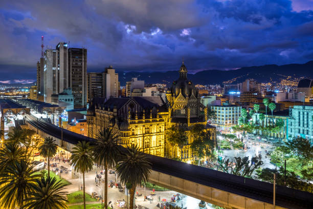 Plaza Botero Square and Downtown Medellin at Dusk in Medellin, Colombia Plaza Botero square and downtown Medellin at dusk in Medellin, Colombia. metro medellin stock pictures, royalty-free photos & images