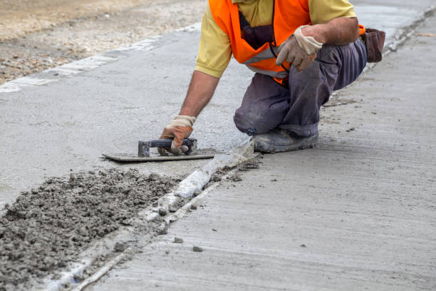 istock Mason leveling concrete with trowel 874126200