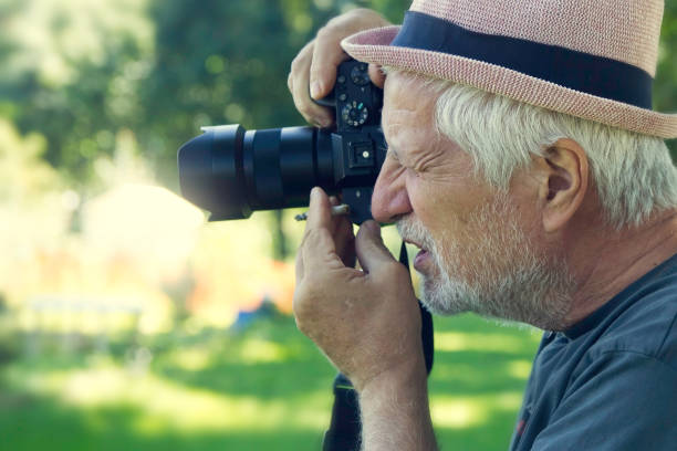 istock senior man photographing 874132656