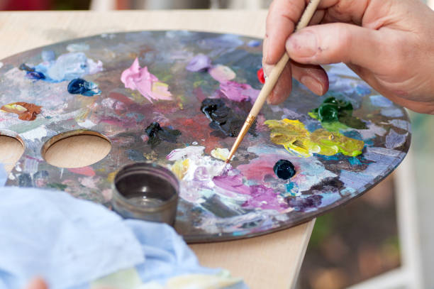 istock artist stirs the paint on a close-up palette 874132842