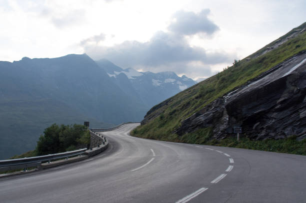 istock Serpentine road and beautiful clouds high in the mountains 874135644