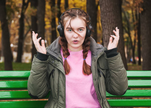 istock Surprised young girl with headphones 874136372