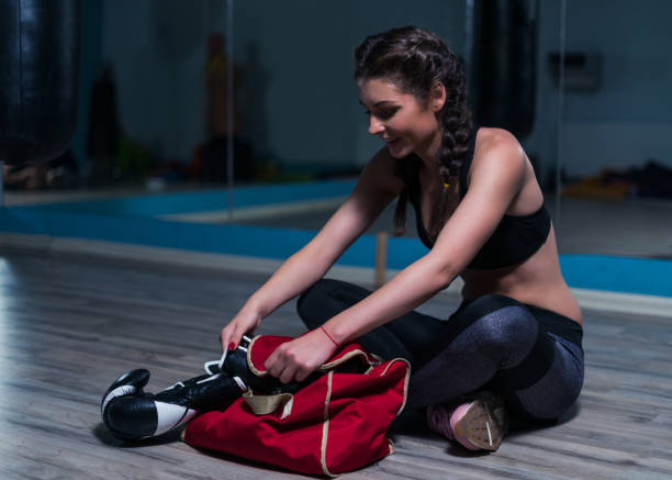 istock Young fighter boxer girl wearing boxing gloves before  training 874139288