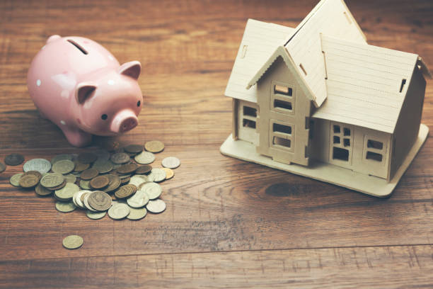 istock model house and piggy bank on coins 874140052