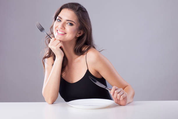 Beautiful woman with knife and fork.