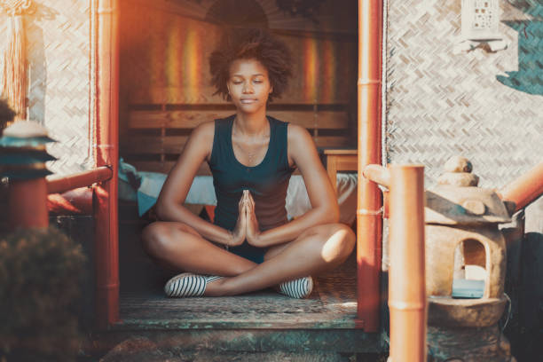 Afro girl meditating with glow over her head