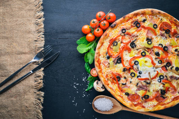 istock Pizza with vegetables. On a wooden background. Top view. Free space for your text. 874147236