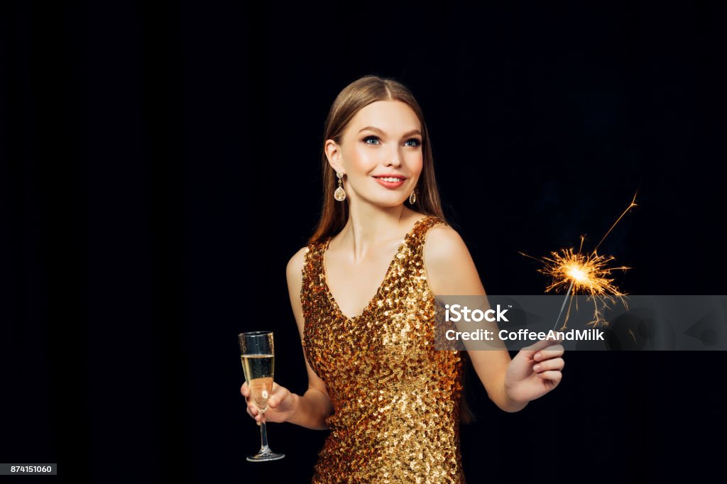 Smiling girl with Christmas sparkler Women Stock Photo