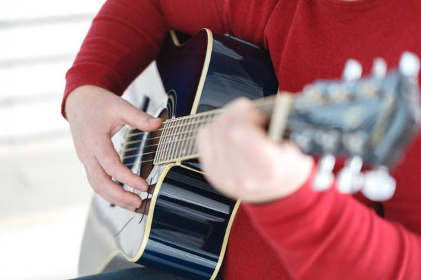 istock hand playing folk guitar action design 874153726