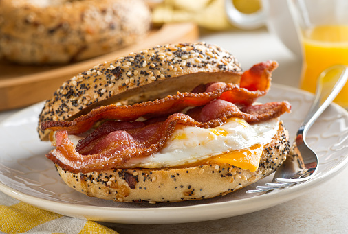 A delicios breakfast bagel with bacon, egg and cheese.