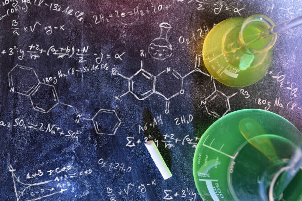 istock Classroom desk and drawn blackboard of chemistry teaching top view 874157678