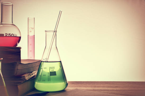 Classroom desk of chemistry teaching with books and instruments. Chemical sciences education concept. Horizontal composition. Front view