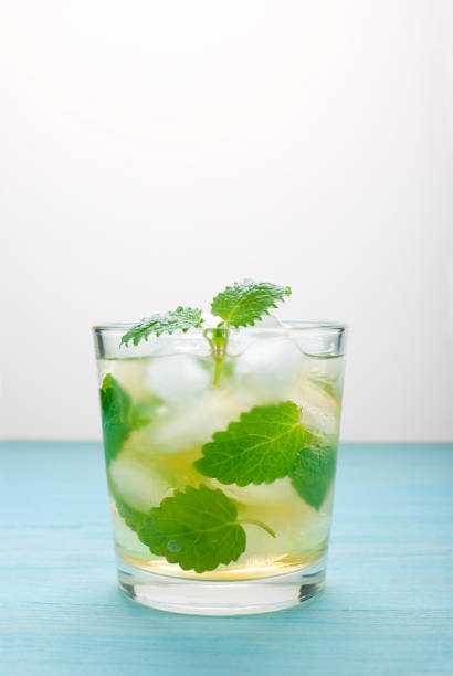 istock cocktail with mint and ice on blue wooden background 874168318