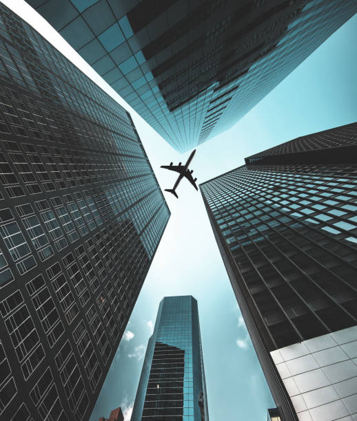 istock airplane flying in manhattan downtown 874168388