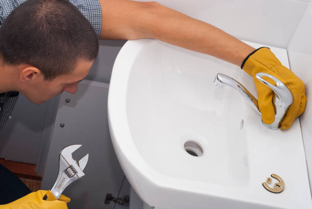 istock plumber installs a new faucet 874169056