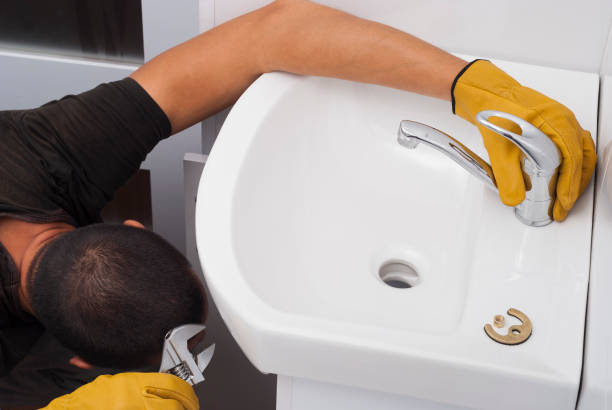 istock plumber installs a new faucet 874169076