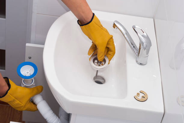 plumber installs a new siphon stock photo