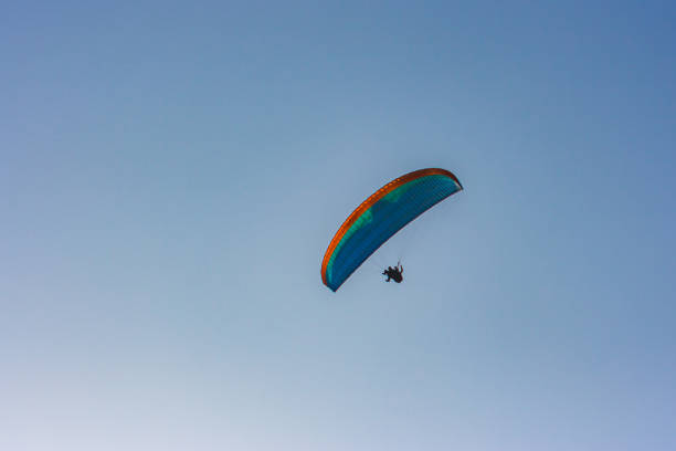 istock Blue and orange paraglider over Lima, Peru 874169318