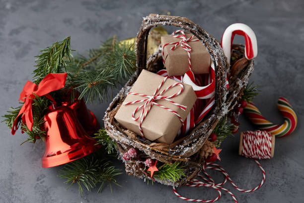 istock Christmas wicker basket with gifts or present boxes 874171764