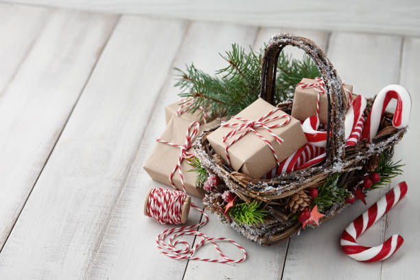istock Christmas wicker basket with gifts or present boxes 874173002