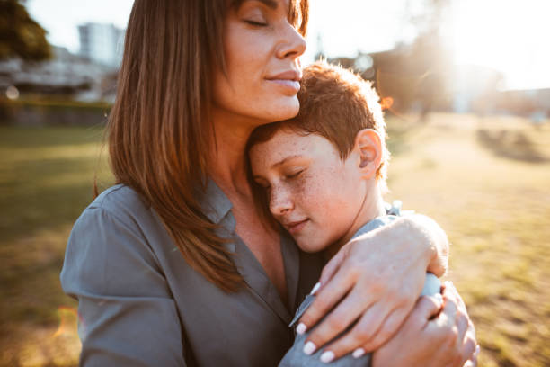istock teenager embraced with mom consoling her son 874174008