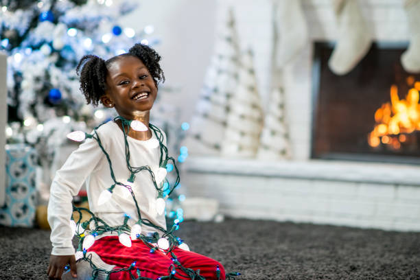 istock Girl With Christmas Lights 874176206