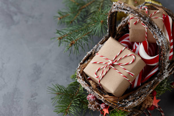 istock Christmas wicker basket with gifts or present boxes 874176476