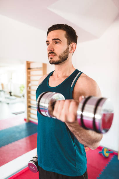 istock fitness man showing the bicep 874176490