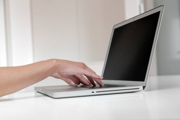 istock Close up of woman's hands typing on a laptop. 874178770