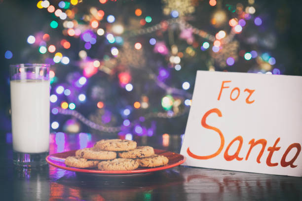 istock Cookies and Milk for Santa on Rustic Wooden Table 874183566
