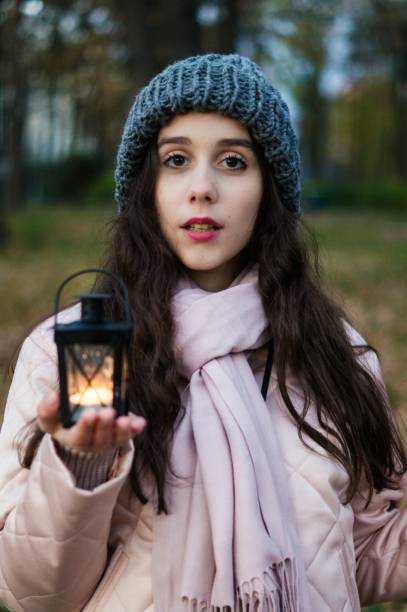 istock Young pretty girl hold retro candlestick 874186868