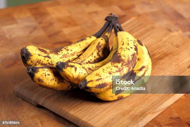 Bunch Of Overripe Bananas On A Wooden Background Stock Photo - Download Image Now - Banana, Ripe, Brown