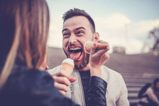 Beautiful Couple Eating Ice Cream in Autumn