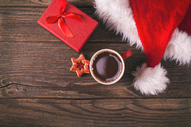 Christmas coffee and gingerbread cookies on rustic wooden table