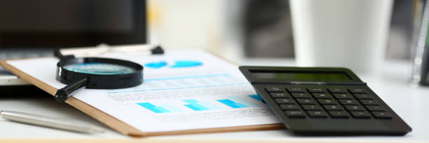 istock at office table closeup. Internal Revenue Service inspector sum check, irs investigation, earnings, savings, loan and credit concept 874190402