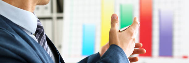 istock Man in suit point with arm in stats graph 874190482
