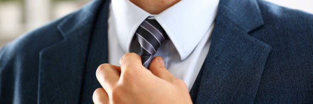 istock Male arm in blue suit set tie closeup 874190526