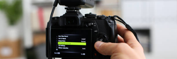 istock Male arms in suit mount camcorder to tripod 874190642