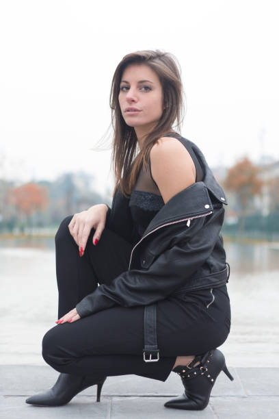 istock Beautiful rock girl crouching 874197652