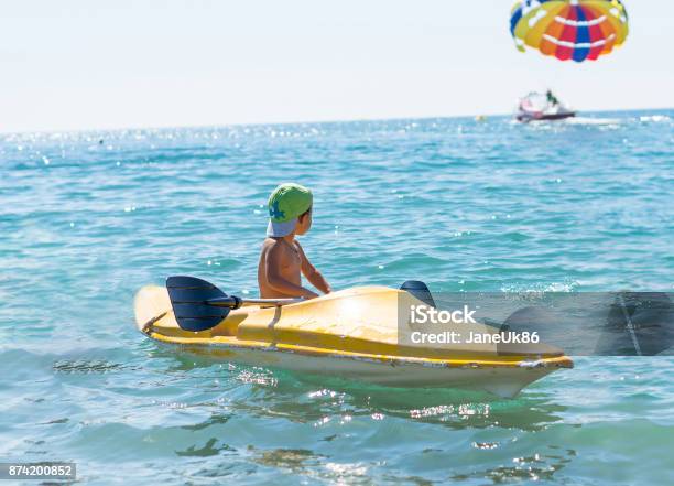 Grandfather And Grandson Smiling Little Baby Boy In Green Baseball Cap Kayaking At Tropical Ocean Sea In The Day Time Positive Human Emotions Feelings Joy Funny Cute Child Making Vacations And Enjoying Summer Happy Family Stock Photo - Download Image Now