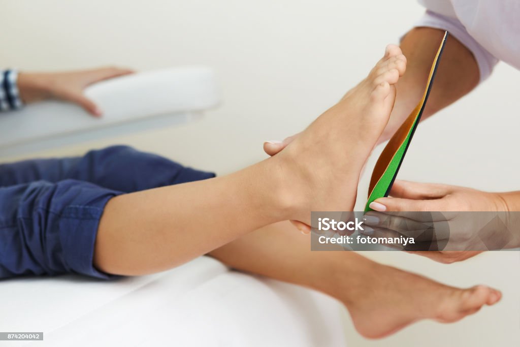 Podiatry clinic. Orthopedic insoles. Fitting orthotic insoles. Flatfoot treatment. Podiatry clinic. Podiatrist Stock Photo