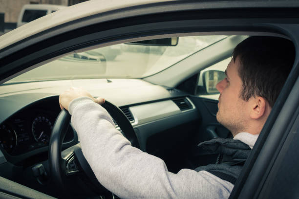 istock Driving safety. A young man driving a car 874205114