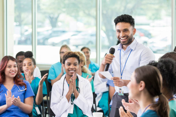 istock Young medical professional asks question during medical seminar 874205428