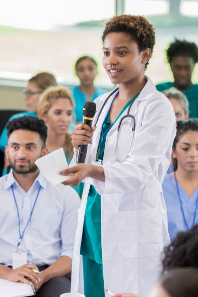 istock Confident healthcare professional asks question during seminar 874205430