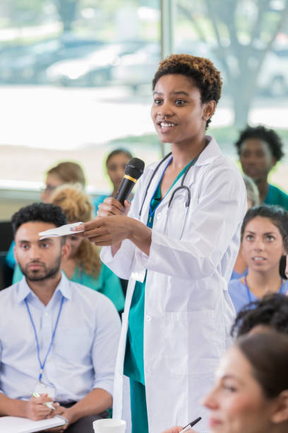 istock Young doctor asks a question during medical seminar 874205434